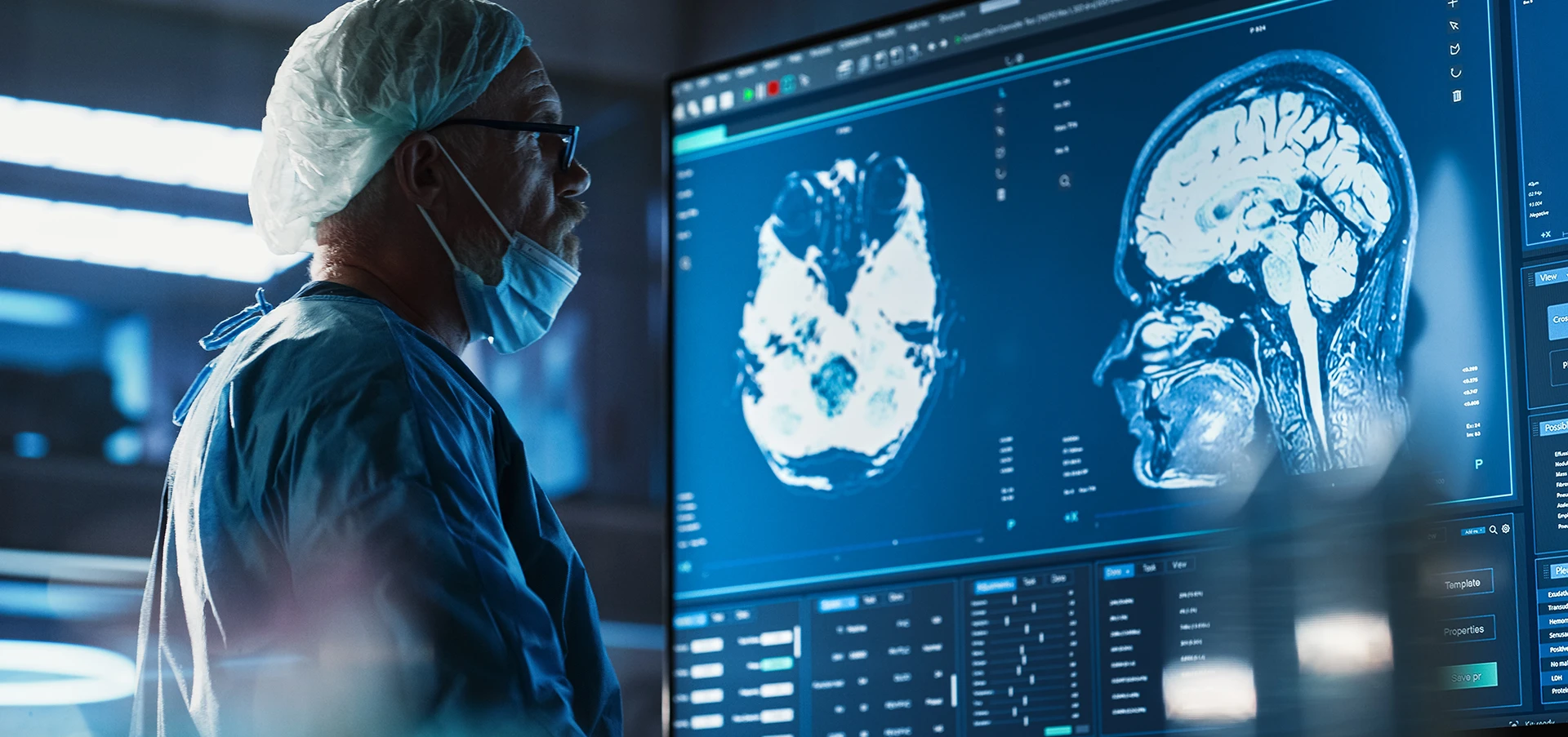 A doctor reviews a brain scan on a large computer screen
